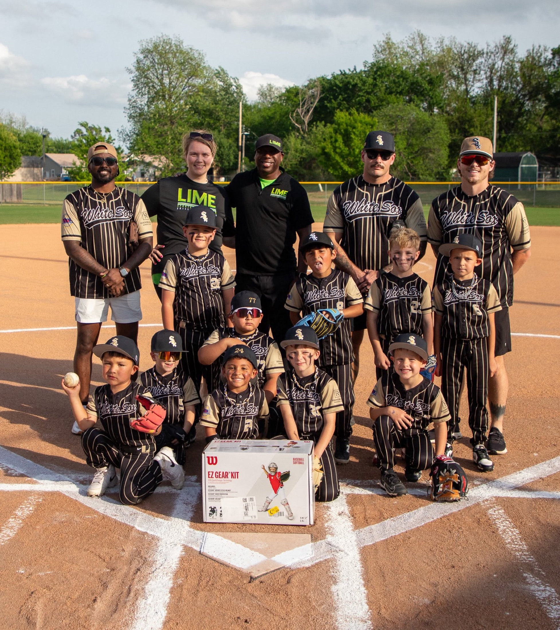 LIME representatives with a youth baseball team and a new catcher’s gear kit