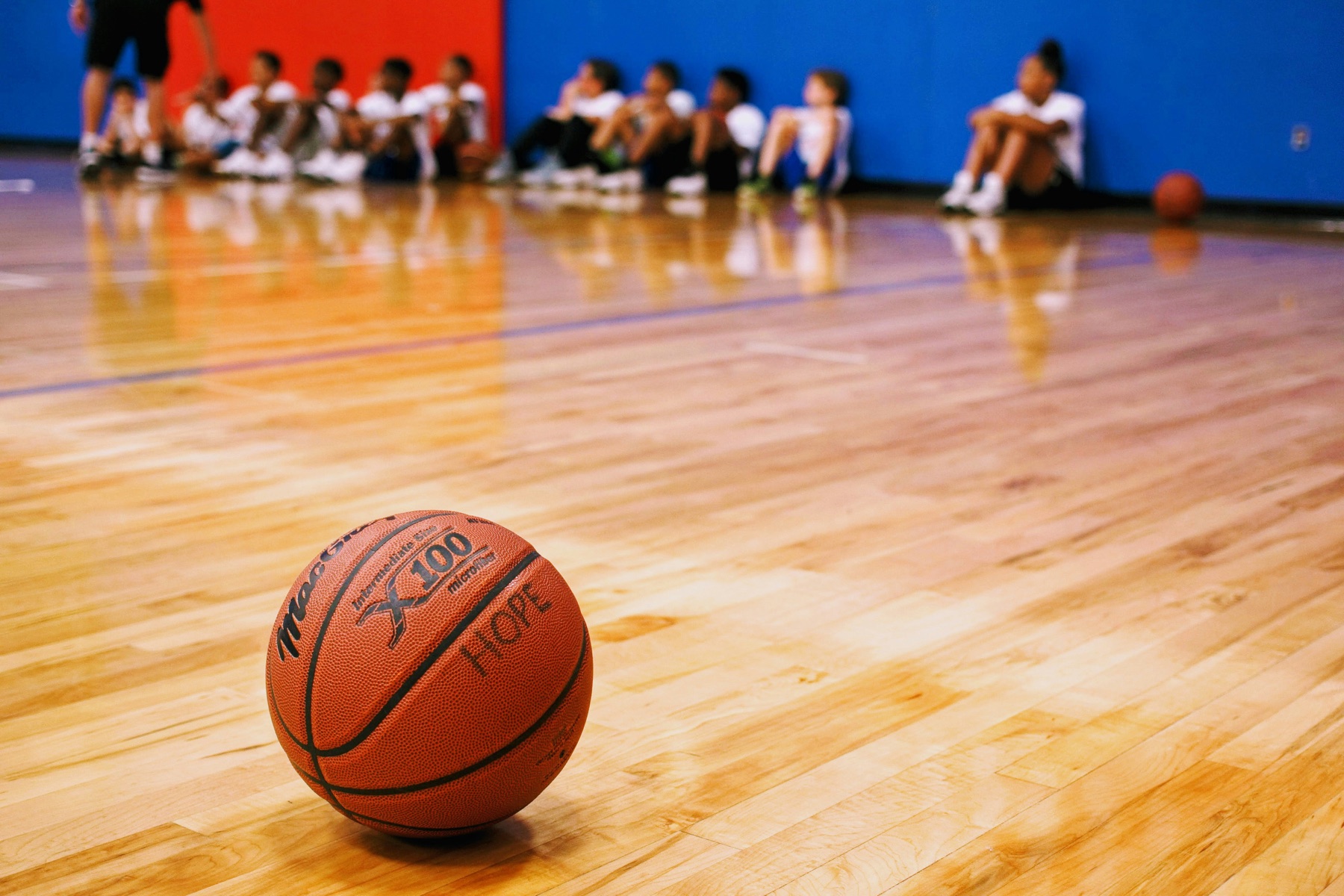 Basketball on a gym floor during a youth camp
